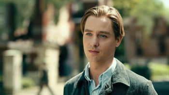 Movie still from “Never Look Away” (2018), directed by Florian Henckel von Donnersmarck – A young man with blonde hair wearing a jacket; Close Up shot, Over the shoulder angle