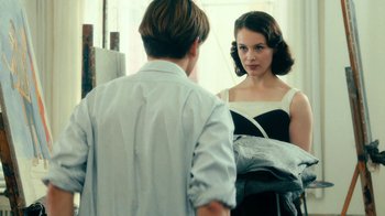 Movie still from “Never Look Away” (2018), directed by Florian Henckel von Donnersmarck – A man and a woman looking at each other in a mirror; Medium shot, Over the shoulder angle
