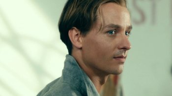 Movie still from “Never Look Away” (2018), directed by Florian Henckel von Donnersmarck – A person wearing a gray shirt; Close Up shot, Low angle