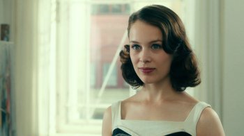 Movie still from “Never Look Away” (2018), directed by Florian Henckel von Donnersmarck – A beautiful young lady wearing a black and white dress; Close Up shot, Over the shoulder angle