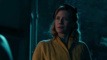Movie still from “Never Look Away” (2018), directed by Florian Henckel von Donnersmarck – A woman in a yellow robe standing in a dark room; Close Up shot, Low angle