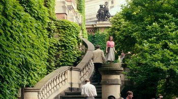 Movie still from “Never Look Away” (2018), directed by Florian Henckel von Donnersmarck – A group of people walking up and down some stairs; Extreme Wide shot, High angle