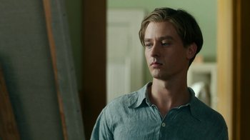 Movie still from “Never Look Away” (2018), directed by Florian Henckel von Donnersmarck – A young man in a blue shirt looking at the camera; Close Up shot, Over the shoulder angle