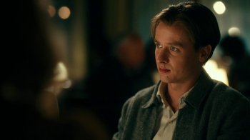 Movie still from “Never Look Away” (2018), directed by Florian Henckel von Donnersmarck – A young man is sitting in front of a camera; Close Up shot, Over the shoulder angle
