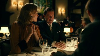 Movie still from “Never Look Away” (2018), directed by Florian Henckel von Donnersmarck – A man and a woman sitting at a dinner table; Medium shot, Over the shoulder angle