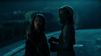 Movie still from “Never Look Away” (2018), directed by Florian Henckel von Donnersmarck – Two people standing next to each other on a street; Medium shot, Low angle