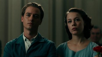 Movie still from “Never Look Away” (2018), directed by Florian Henckel von Donnersmarck – A man and a woman standing next to each other; Close Up shot, Low angle