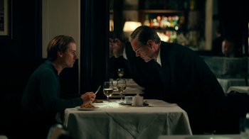 Movie still from “Never Look Away” (2018), directed by Florian Henckel von Donnersmarck – A man and a woman sitting at a dinner table; Medium shot, Over the shoulder angle