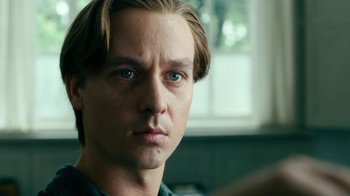 Movie still from “Never Look Away” (2018), directed by Florian Henckel von Donnersmarck – A person with long blonde hair; Close Up shot, Over the shoulder angle