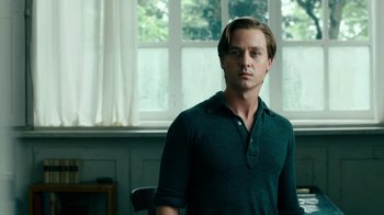 Movie still from “Never Look Away” (2018), directed by Florian Henckel von Donnersmarck – A man standing in front of a window in a room; Medium shot, Low angle