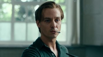 Movie still from “Never Look Away” (2018), directed by Florian Henckel von Donnersmarck – A man with a cigarette in his mouth; Close Up shot, Low angle