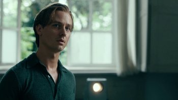 Movie still from “Never Look Away” (2018), directed by Florian Henckel von Donnersmarck – A man standing in front of a window in a room; Close Up shot, Low angle