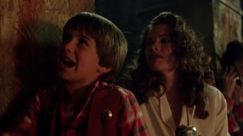 Movie still from “New Nightmare” (1994), directed by Wes Craven – A boy and a woman standing next to each other; Close Up shot, Over the shoulder angle