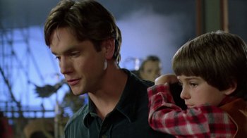 Movie still from “New Nightmare” (1994), directed by Wes Craven – A man and a boy standing next to each other; Close Up shot, Over the shoulder angle