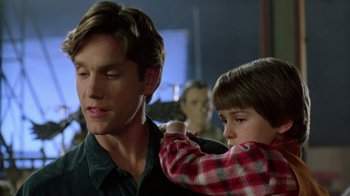 Movie still from “New Nightmare” (1994), directed by Wes Craven – A man and a child are looking at each other; Close Up shot, Over the shoulder angle