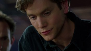 Movie still from “New Nightmare” (1994), directed by Wes Craven – A man's face as he stares into the distance; Close Up shot, High angle