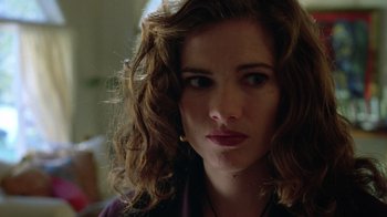 Movie still from “New Nightmare” (1994), directed by Wes Craven – A person with curly brown hair; Close Up shot, Low angle