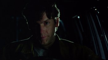 Movie still from “New Nightmare” (1994), directed by Wes Craven – A person in a dark room; Close Up shot, Low angle
