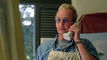 Movie still from “New Nightmare” (1994), directed by Wes Craven – A man in a apron talking on a cell phone; Close Up shot, Low angle