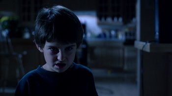 Movie still from “New Nightmare” (1994), directed by Wes Craven – A young boy is looking into the camera; Close Up shot, Low angle