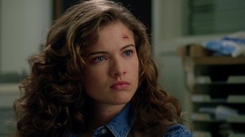 Movie still from “New Nightmare” (1994), directed by Wes Craven – A person wearing a blue shirt; Close Up shot, Over the shoulder angle