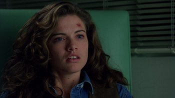 Movie still from “New Nightmare” (1994), directed by Wes Craven – A person with a bruise on her face; Close Up shot, Over the shoulder angle
