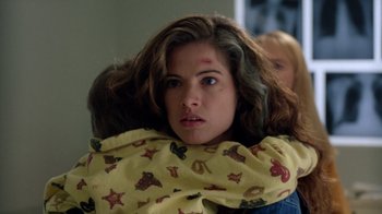 Movie still from “New Nightmare” (1994), directed by Wes Craven – A young woman wrapped up in a blanket; Close Up shot, Over the shoulder angle