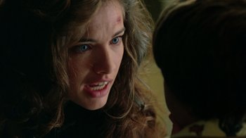 Movie still from “New Nightmare” (1994), directed by Wes Craven – A young woman with a bruised face looking at a young man; Close Up shot, Over the shoulder angle
