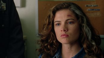 Movie still from “New Nightmare” (1994), directed by Wes Craven – A person with a bruise on her face; Close Up shot, Over the shoulder angle