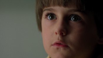 Movie still from “New Nightmare” (1994), directed by Wes Craven – A child's eyes and face; Extreme Close Up shot, Low angle