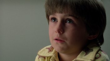 Movie still from “New Nightmare” (1994), directed by Wes Craven – A young child looking at the camera; Close Up shot, Low angle
