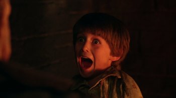 Movie still from “New Nightmare” (1994), directed by Wes Craven – A young boy with his mouth wide open; Close Up shot, High angle