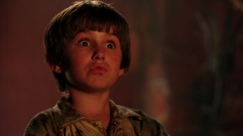 Movie still from “New Nightmare” (1994), directed by Wes Craven – A young boy with a surprised look on his face; Close Up shot, Low angle