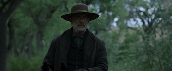 Movie still from “News of the World” (2020), directed by Paul Greengrass – An older man wearing a hat and a coat; Medium shot, Over the shoulder angle