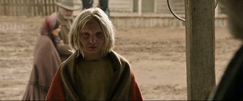 Movie still from “News of the World” (2020), directed by Paul Greengrass – A young girl in a blanket standing in the dirt; Close Up shot, Low angle