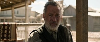 Movie still from “News of the World” (2020), directed by Paul Greengrass – An older man with a beard and a vest; Close Up shot, Over the shoulder angle