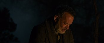 Movie still from “News of the World” (2020), directed by Paul Greengrass – An older man in a brown jacket is looking down at his face; Close Up shot, Low angle