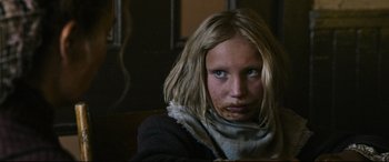 Movie still from “News of the World” (2020), directed by Paul Greengrass – A young girl with a messy face sitting on a chair; Close Up shot, Over the shoulder angle