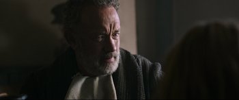 Movie still from “News of the World” (2020), directed by Paul Greengrass – An older man wearing a sweater and a scarf; Close Up shot, Over the shoulder angle