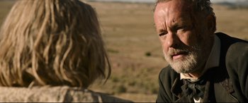 Movie still from “News of the World” (2020), directed by Paul Greengrass – An older man and a young woman in a field; Close Up shot, Over the shoulder angle