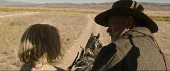 Movie still from “News of the World” (2020), directed by Paul Greengrass – A man and a woman riding a horse drawn carriage down a dirt road; Close Up shot, Over the shoulder angle