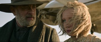 Movie still from “News of the World” (2020), directed by Paul Greengrass – A man and a woman standing next to each other under an umbrella; Close Up shot, Low angle