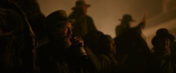 Movie still from “News of the World” (2020), directed by Paul Greengrass – A man in a hat is holding a bottle of wine; Close Up shot, Over the shoulder angle