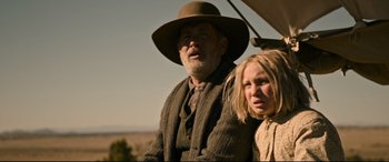 Movie still from “News of the World” (2020), directed by Paul Greengrass – An older man and a young girl are standing together; Medium shot, Low angle