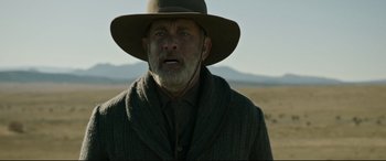 Movie still from “News of the World” (2020), directed by Paul Greengrass – An older man wearing a hat in a field; Close Up shot, Low angle