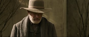 Movie still from “News of the World” (2020), directed by Paul Greengrass – An old man with a beard wearing a hat; Close Up shot, Low angle