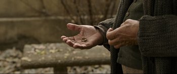 Movie still from “News of the World” (2020), directed by Paul Greengrass – A man holding his hands with a wedding ring in it; Extreme Close Up shot, High angle