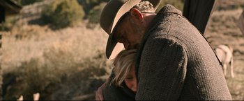 Movie still from “News of the World” (2020), directed by Paul Greengrass – A man and a woman hugging in a field; Close Up shot, Over the shoulder angle
