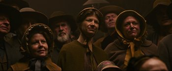 Movie still from “News of the World” (2020), directed by Paul Greengrass – A group of people wearing hats and standing in a room; Close Up shot, Low angle