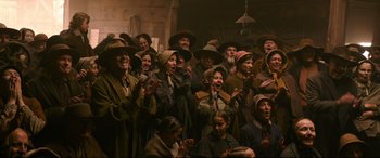 Movie still from “News of the World” (2020), directed by Paul Greengrass – A group of people wearing hats and smiling; Wide shot, High angle